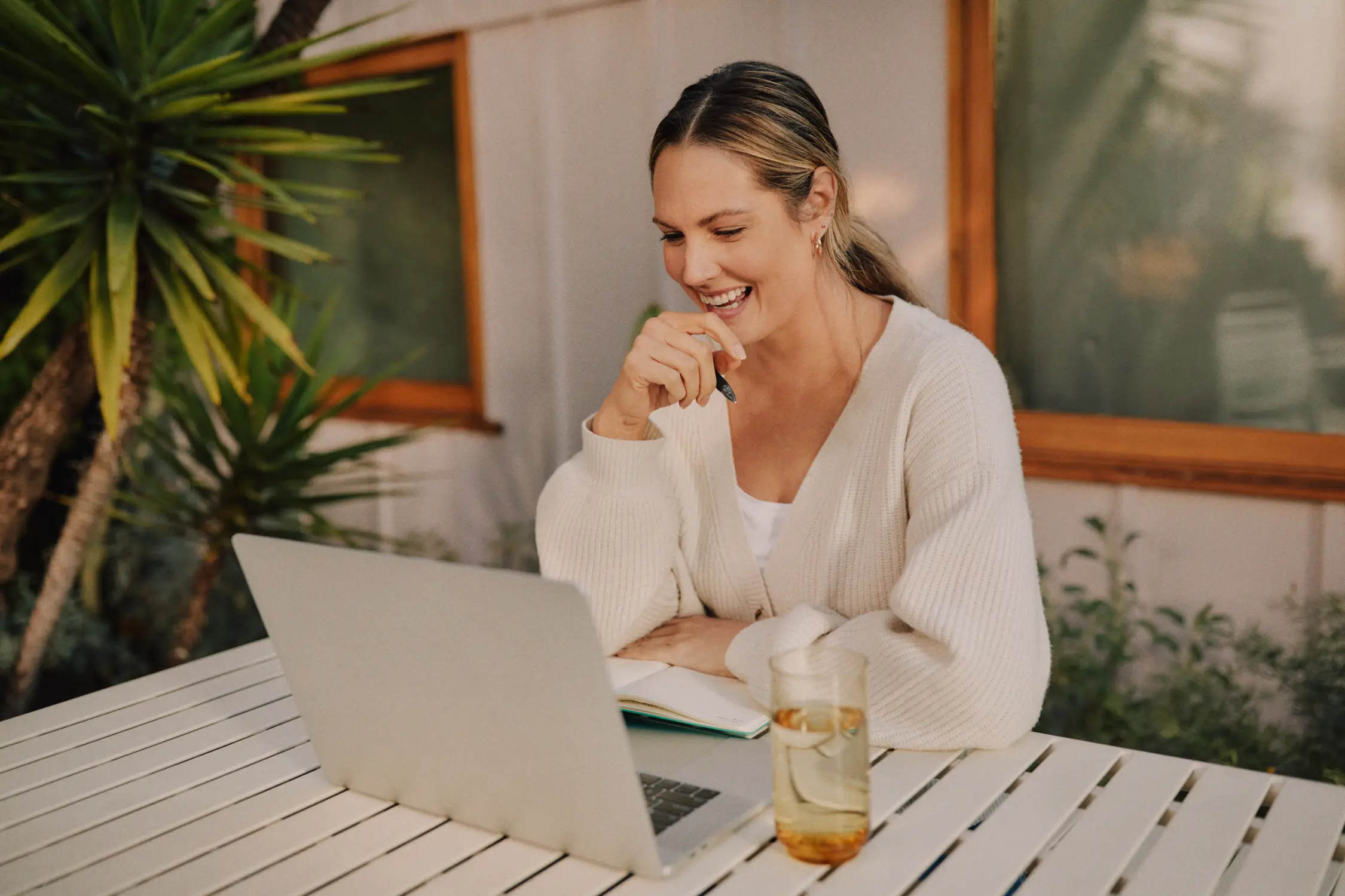 Woman looking at computer smiling