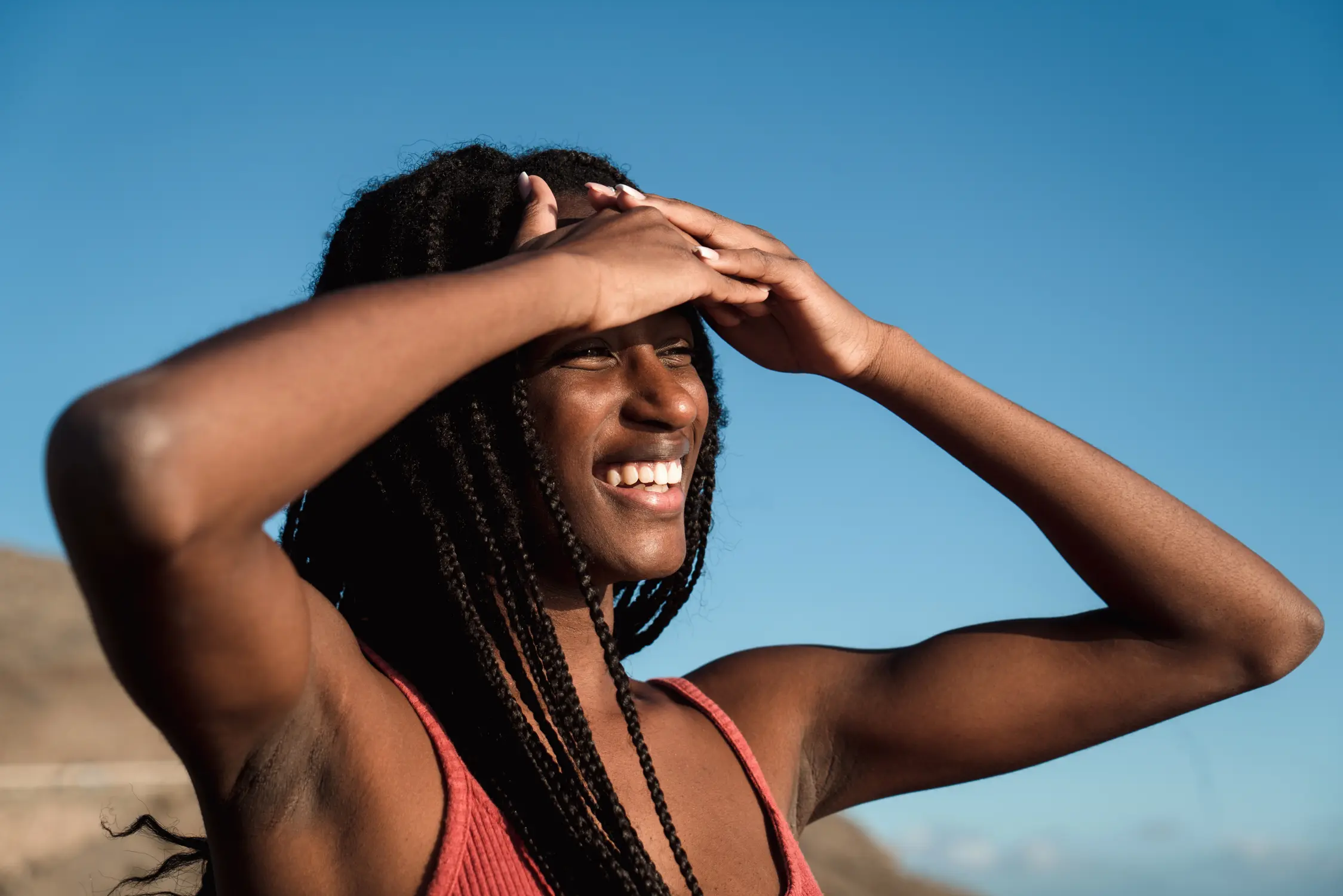 Woman working out shielding eyes